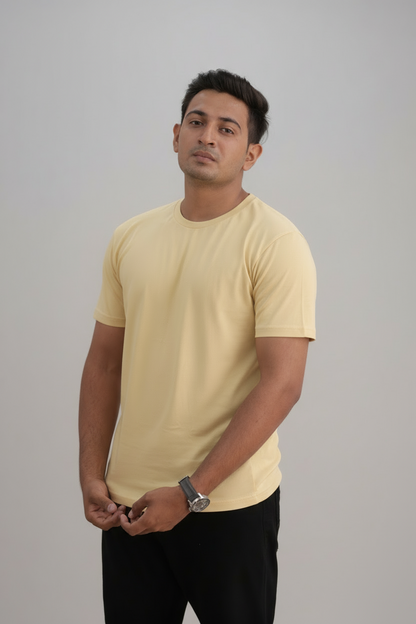 Man wearing a yellow t-shirt against a gray background