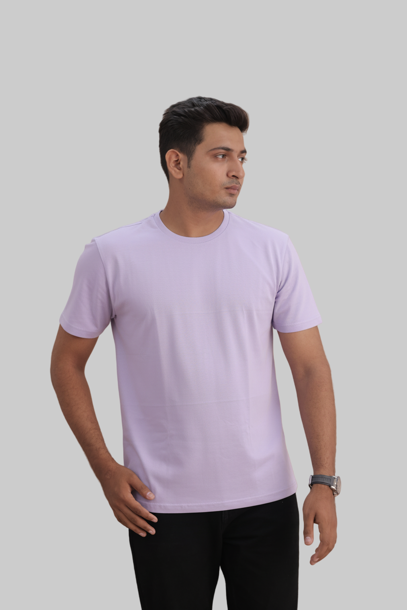 Man wearing a lavender t-shirt against a gray background